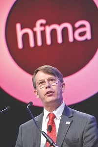 Mr Baumann speaking and HFMA brand
